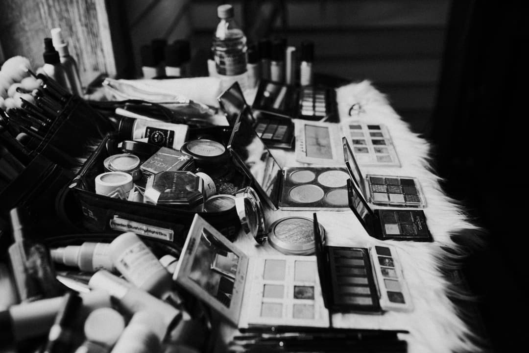 A table of makeup (setting powders, blushes, etc.) in a black and white style